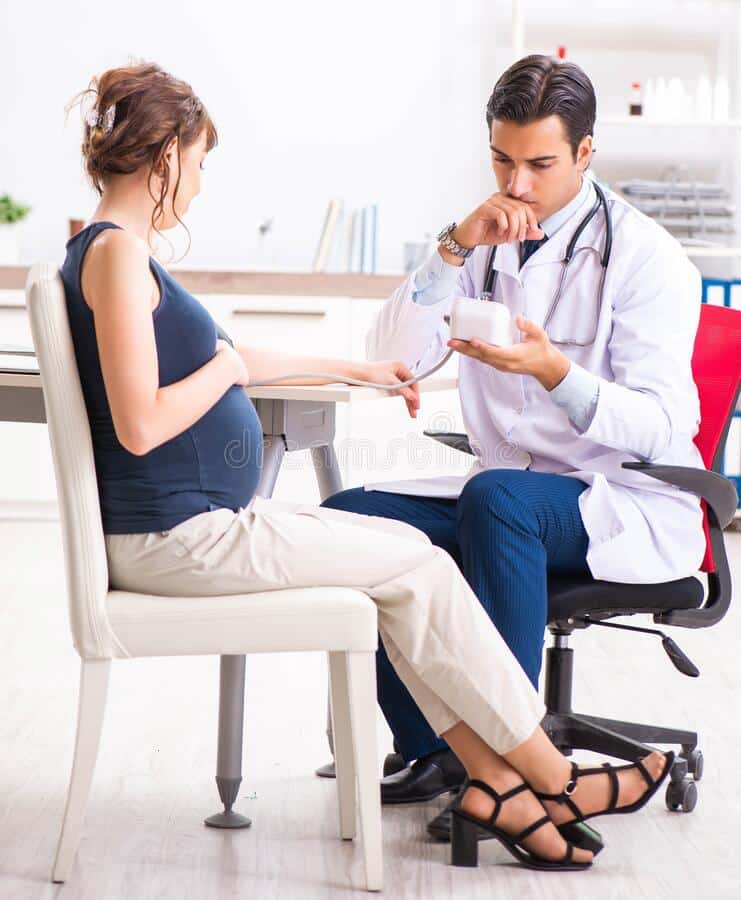 Young Doctor Checking Pregnant Woman`s Blood Pressure Stock Image ...